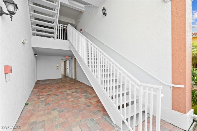 stairway featuring a high ceiling