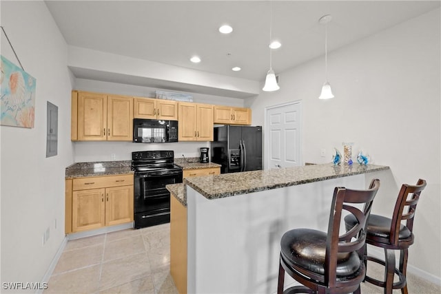 kitchen featuring hanging light fixtures, a kitchen breakfast bar, kitchen peninsula, light brown cabinetry, and black appliances