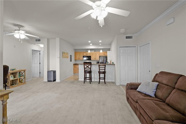 living room with light colored carpet, ceiling fan, and ornamental molding