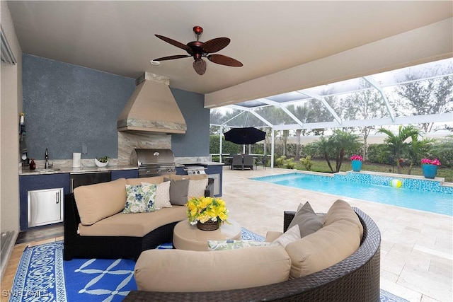 view of patio with an outdoor kitchen, ceiling fan, an outdoor hangout area, and glass enclosure