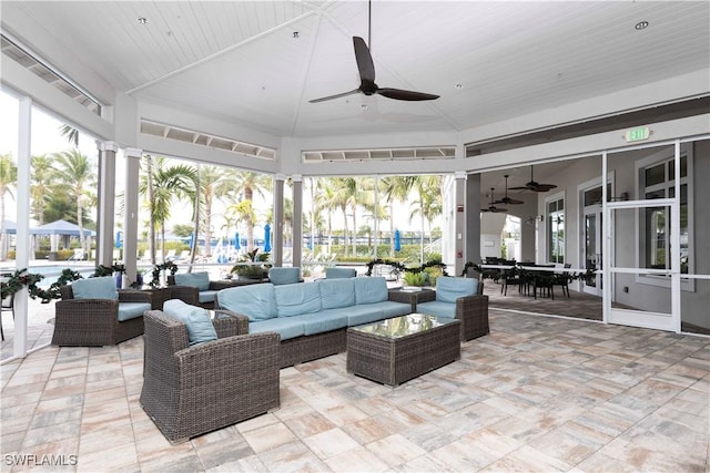 sunroom / solarium with ceiling fan and vaulted ceiling