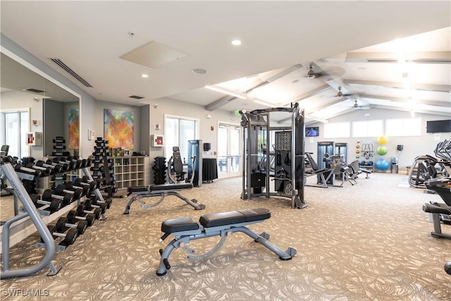 exercise room featuring carpet, ceiling fan, and vaulted ceiling