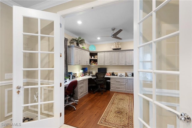 home office with ceiling fan, dark hardwood / wood-style flooring, built in desk, and crown molding