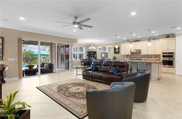 living room with crown molding, light tile patterned floors, and ceiling fan with notable chandelier