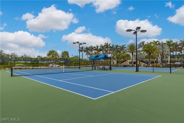 view of tennis court featuring basketball court