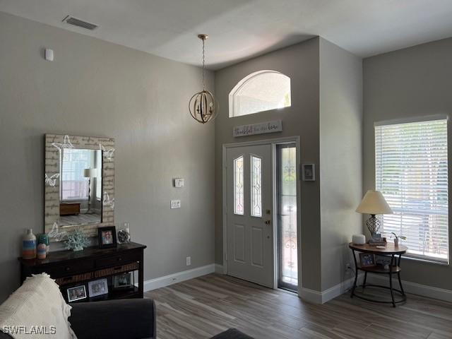 entrance foyer with hardwood / wood-style flooring and a notable chandelier