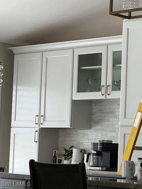 kitchen featuring white cabinets and decorative backsplash