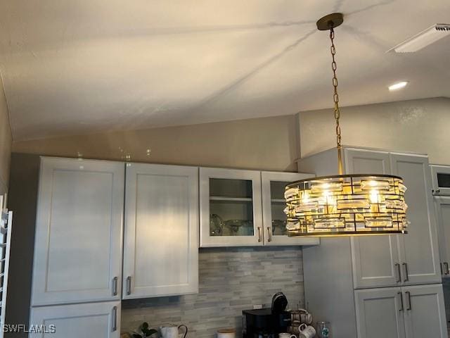 room details featuring white cabinets and tasteful backsplash