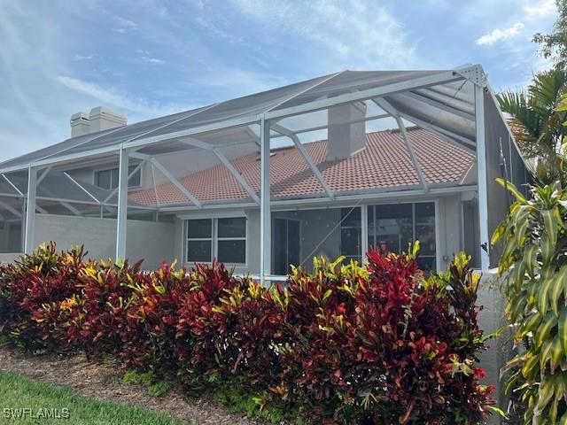 rear view of property with a lanai