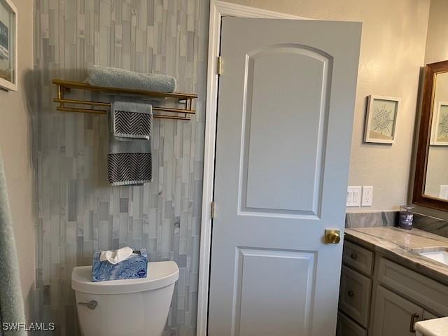 bathroom featuring vanity and toilet