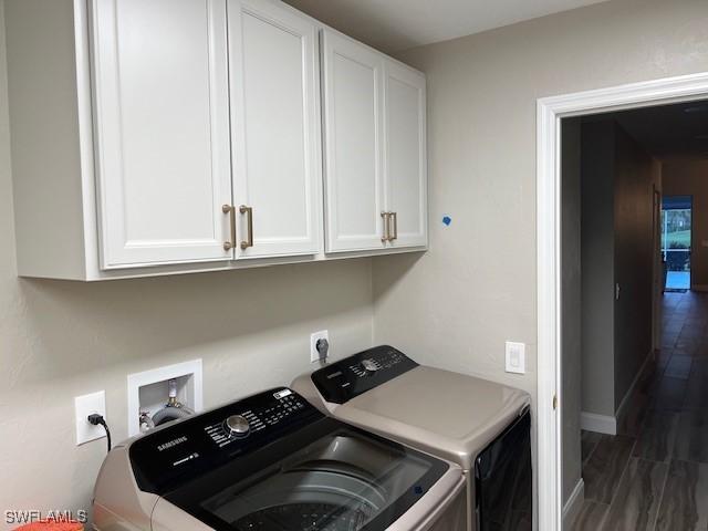 laundry room featuring cabinets and separate washer and dryer