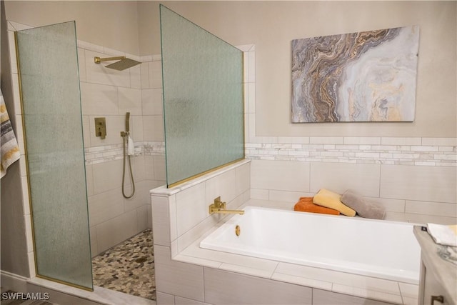 bathroom featuring separate shower and tub