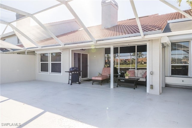 back of house with a patio and glass enclosure