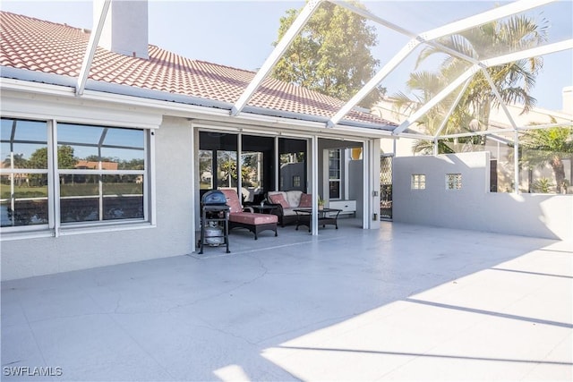 exterior space featuring a lanai, outdoor lounge area, and a patio