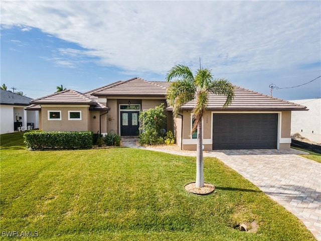 view of front of property with a garage and a front yard