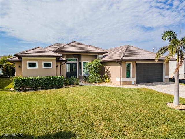 view of front of home with french doors, a garage, and a front yard