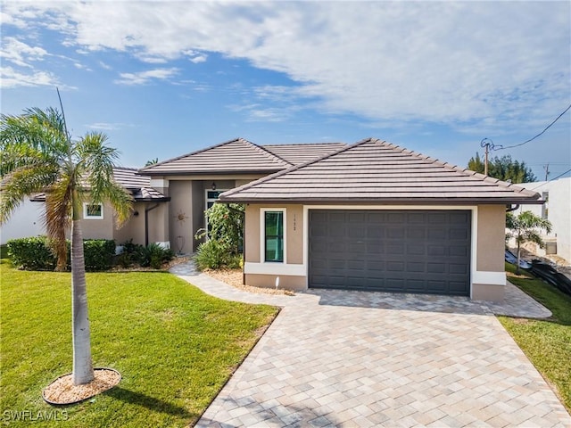 view of front facade with a garage and a front yard