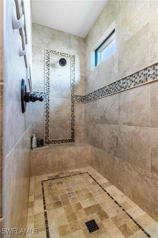 bathroom with a tile shower