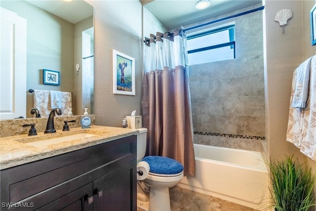 full bathroom with shower / tub combo with curtain, vanity, and toilet