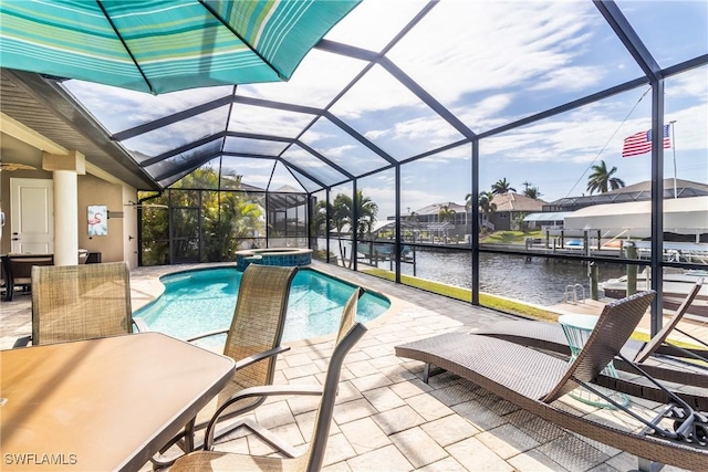 view of pool with a patio, a water view, an in ground hot tub, and a lanai