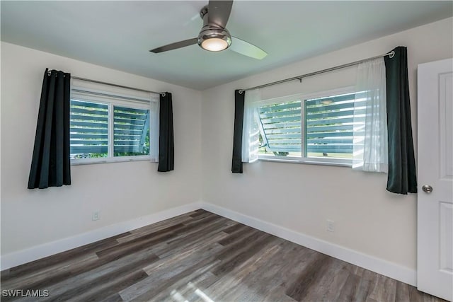 empty room featuring ceiling fan and dark hardwood / wood-style flooring