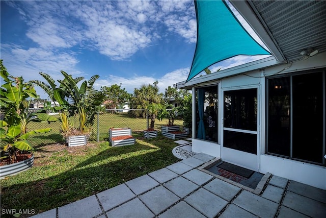 view of patio with a sunroom