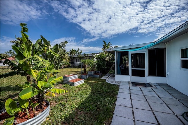 view of yard featuring a sunroom