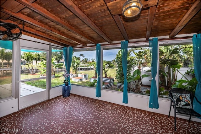 unfurnished sunroom featuring lofted ceiling with beams and wood ceiling