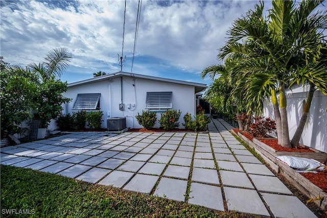 rear view of house with a patio and central AC