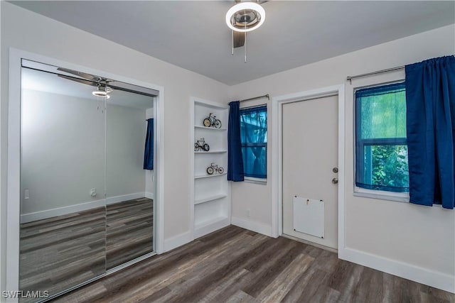 entrance foyer with ceiling fan and dark wood-type flooring