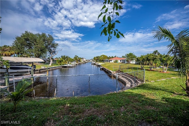 dock area with a water view and a yard