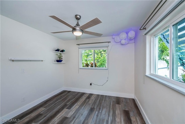 empty room featuring dark hardwood / wood-style flooring and ceiling fan