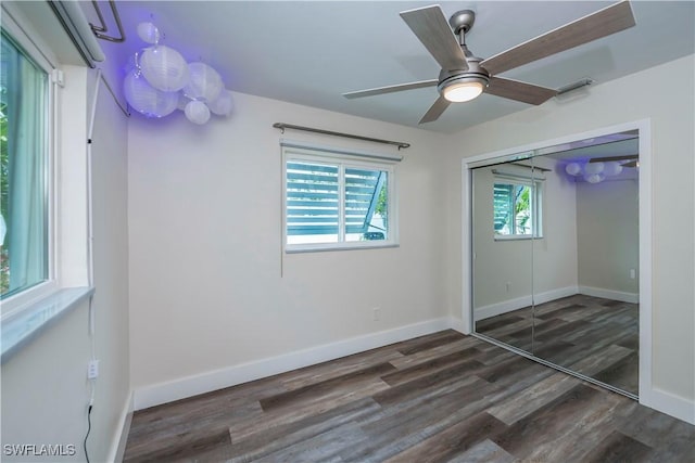 unfurnished bedroom featuring ceiling fan, dark hardwood / wood-style flooring, and a closet