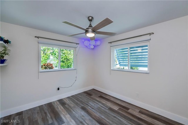 spare room featuring ceiling fan and dark hardwood / wood-style floors