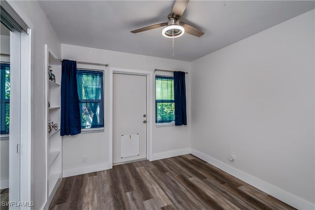 spare room with ceiling fan and dark wood-type flooring