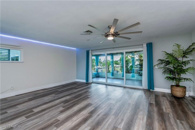 spare room featuring ceiling fan and dark wood-type flooring