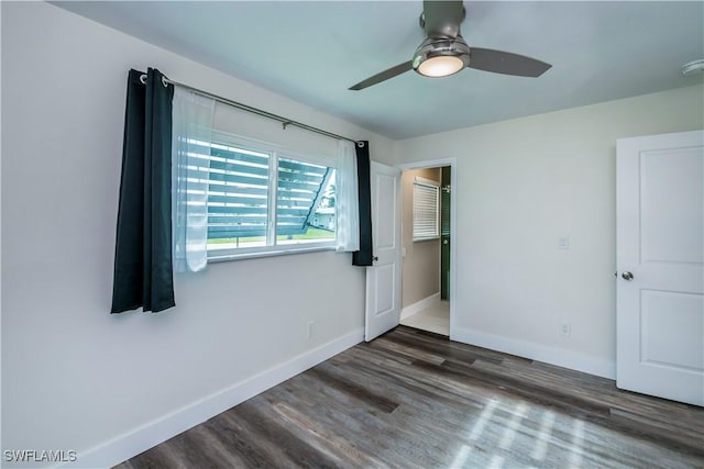 unfurnished bedroom featuring ceiling fan and dark wood-type flooring