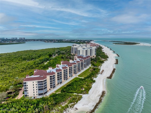 birds eye view of property featuring a water view and a beach view