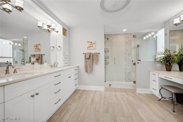 bathroom featuring hardwood / wood-style flooring, vanity, and a shower with shower door