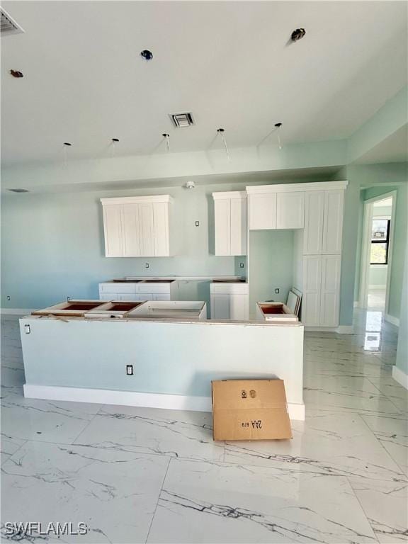 kitchen featuring a center island and white cabinets