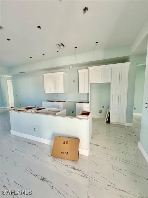 kitchen with a center island and white cabinets