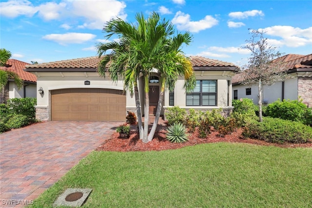 mediterranean / spanish-style home featuring a garage and a front yard