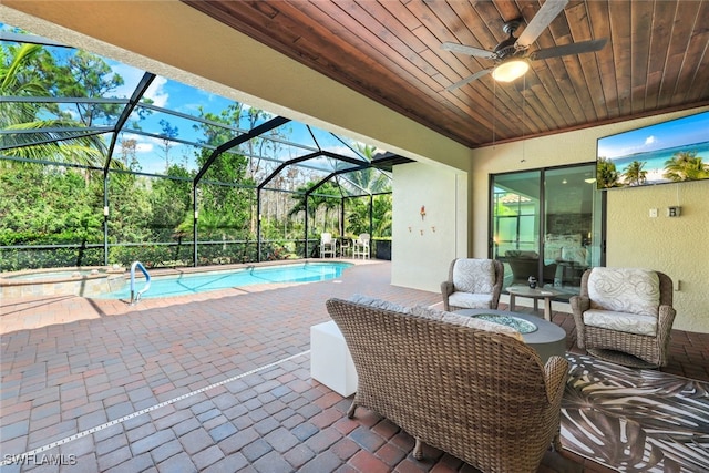 view of patio featuring a ceiling fan, outdoor lounge area, an outdoor pool, an in ground hot tub, and a lanai