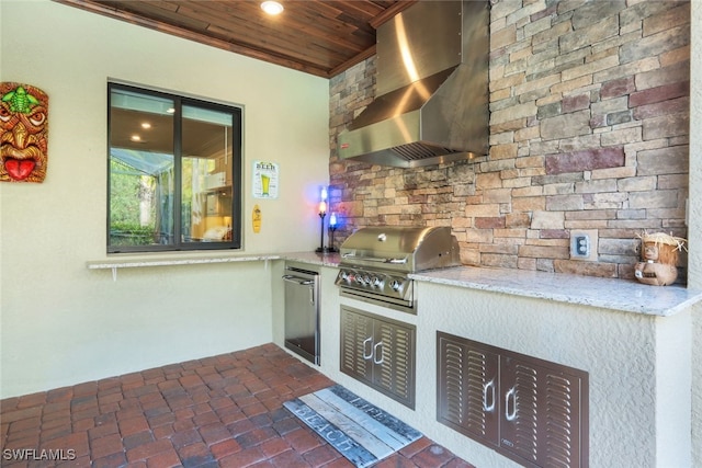 kitchen with light stone countertops, refrigerator, wood ceiling, and wall chimney range hood