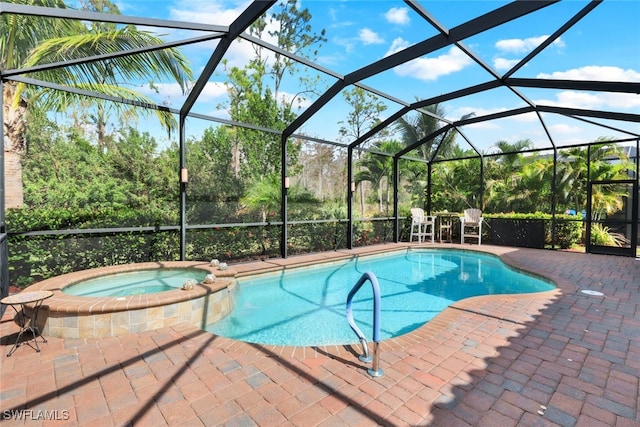 view of pool with a lanai, a patio area, and an in ground hot tub