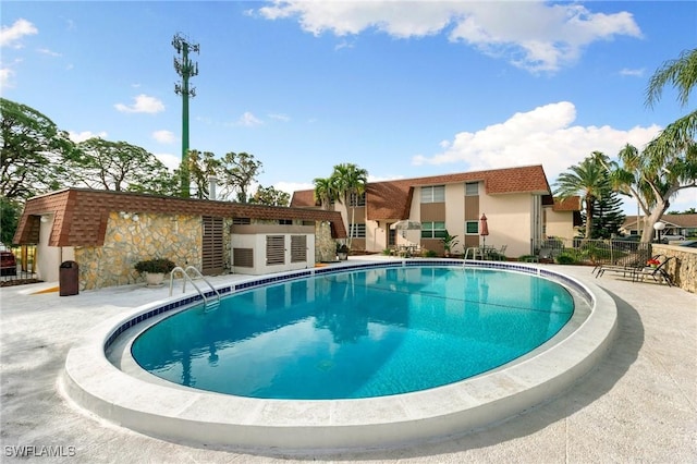 view of swimming pool featuring a patio