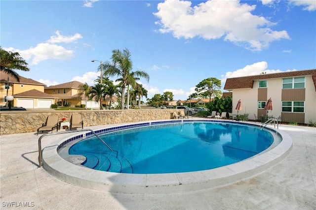 view of swimming pool featuring a patio area