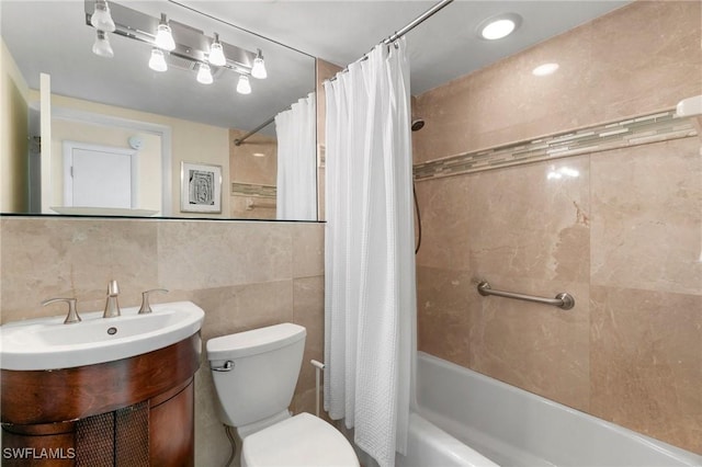 full bathroom featuring backsplash, toilet, shower / bath combo with shower curtain, vanity, and tile walls