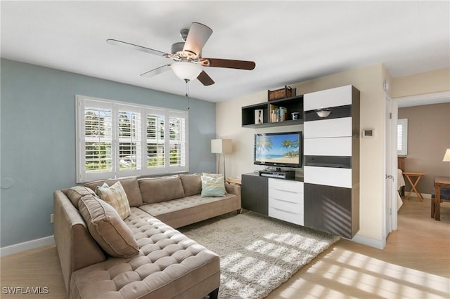 living room with light wood-type flooring and ceiling fan