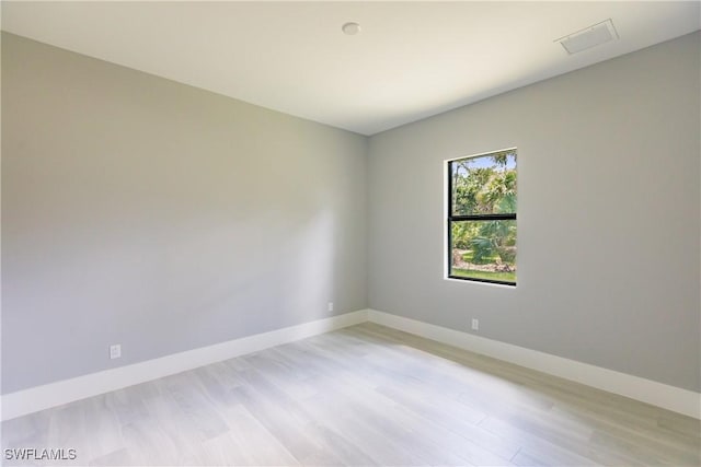 spare room featuring light hardwood / wood-style flooring